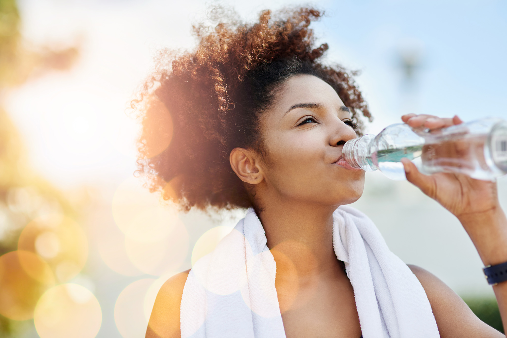 Woman drinking water at Life Time Living